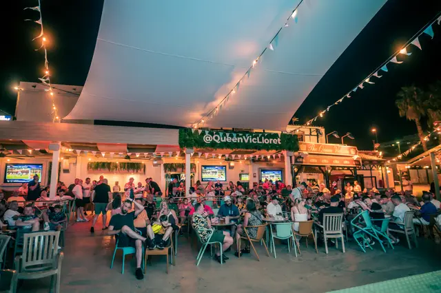 World Cup night on the Queen Vic terrace, sail shades and festoon lights over a full crowd